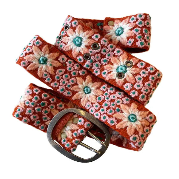  Photo of colorful hand-embroidered floral wool belt by Jenny Krauss, made in Peru with lead-free metal buckle. Versatile design with five sets of 2" spaced holes for hip or waist wear, featuring slight stretch for comfort.
