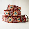 Photo of colorful hand-embroidered floral wool belt by Jenny Krauss, made in Peru with lead-free metal buckle. Versatile design with five sets of 2" spaced holes for hip or waist wear, featuring slight stretch for comfort.