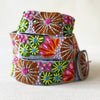 Photo of colorful hand-embroidered floral wool belt by Jenny Krauss, made in Peru with lead-free metal buckle. Versatile design with five sets of 2" spaced holes for hip or waist wear, featuring slight stretch for comfort.