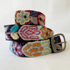 Photo of colorful hand-embroidered floral wool belt by Jenny Krauss, made in Peru with lead-free metal buckle. Versatile design with five sets of 2" spaced holes for hip or waist wear, featuring slight stretch for comfort.