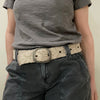 Photo of monochromatic  hand-embroidered floral wool belt by Jenny Krauss, made in Peru with lead-free metal buckle. Versatile design with five sets of 2" spaced holes for hip or waist wear, featuring slight stretch for comfort.