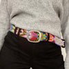 
Photo of colorful hand-embroidered floral wool belt by Jenny Krauss, made in Peru with lead-free metal buckle. Versatile design with five sets of 2" spaced holes for hip or waist wear, featuring slight stretch for comfort.
