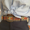 Photo of colorful hand-embroidered floral wool belt by Jenny Krauss, made in Peru with lead-free metal buckle. Versatile design with five sets of 2" spaced holes for hip or waist wear, featuring slight stretch for comfort.