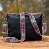 Photo of Jenny Krauss hand-embroidered wool strap from Peru. Multi-functional design serves as a bag or camera strap. Vibrant floral pattern, lead-free metal hardware, and adjustable length for versatile use. Elevate your style with this artisanal accessory.