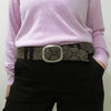 Photo of monochromatic  hand-embroidered floral wool belt by Jenny Krauss, made in Peru with lead-free metal buckle. Versatile design with five sets of 2" spaced holes for hip or waist wear, featuring slight stretch for comfort.