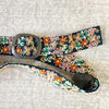 Photo of monochromatic  hand-embroidered floral wool belt by Jenny Krauss, made in Peru with lead-free metal buckle. Versatile design with five sets of 2" spaced holes for hip or waist wear, featuring slight stretch for comfort.