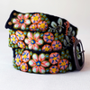 Photo of colorful hand-embroidered floral wool belt by Jenny Krauss, made in Peru with lead-free metal buckle. Versatile design with five sets of 2" spaced holes for hip or waist wear, featuring slight stretch for comfort.
