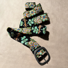 Photo of colorful hand-embroidered floral wool belt by Jenny Krauss, made in Peru with lead-free metal buckle. Versatile design with five sets of 2" spaced holes for hip or waist wear, featuring slight stretch for comfort.