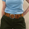 Photo of monochromatic  hand-embroidered floral wool belt by Jenny Krauss, made in Peru with lead-free metal buckle. Versatile design with five sets of 2" spaced holes for hip or waist wear, featuring slight stretch for comfort.