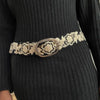 Photo of monochromatic  hand-embroidered floral wool belt by Jenny Krauss, made in Peru with lead-free metal buckle. Versatile design with five sets of 2" spaced holes for hip or waist wear, featuring slight stretch for comfort.