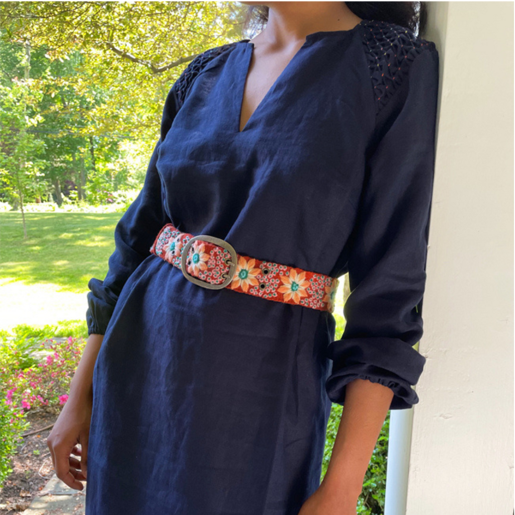 Photo of colorful hand-embroidered floral wool belt by Jenny Krauss, made in Peru with lead-free metal buckle. Versatile design with five sets of 2" spaced holes for hip or waist wear, featuring slight stretch for comfort.