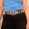 Photo of colorful hand-embroidered floral wool belt by Jenny Krauss, made in Peru with lead-free metal buckle. Versatile design with five sets of 2" spaced holes for hip or waist wear, featuring slight stretch for comfort.