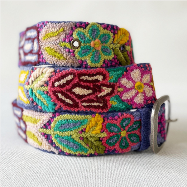 Photo of colorful hand-embroidered floral wool belt by Jenny Krauss, made in Peru with lead-free metal buckle. Versatile design with five sets of 2" spaced holes for hip or waist wear, featuring slight stretch for comfort.