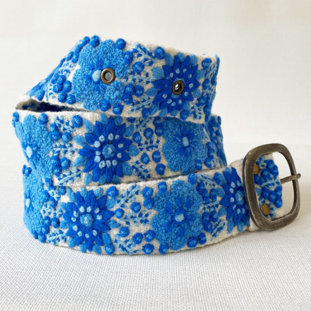 Photo of colorful hand-embroidered floral wool belt by Jenny Krauss, made in Peru with lead-free metal buckle. Versatile design with five sets of 2" spaced holes for hip or waist wear, featuring slight stretch for comfort.