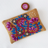 Embroidered pouch with floral design on a white background
