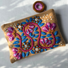 Embroidered pouch with floral design on a white background