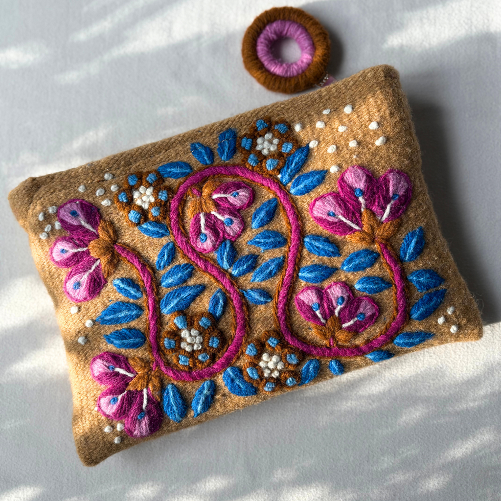 Embroidered pouch with floral design on a white background