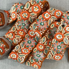 Photo of colorful hand-embroidered floral wool belt by Jenny Krauss, made in Peru with lead-free metal buckle. Versatile design with five sets of 2" spaced holes for hip or waist wear, featuring slight stretch for comfort.