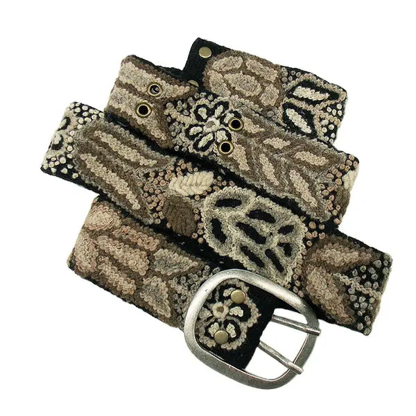 Photo of monochromatic  hand-embroidered floral wool belt by Jenny Krauss, made in Peru with lead-free metal buckle. Versatile design with five sets of 2" spaced holes for hip or waist wear, featuring slight stretch for comfort.